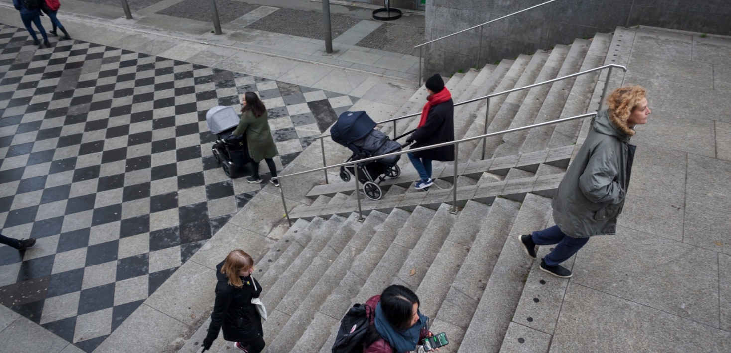 People walkning down stairs in a city