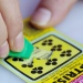 A lottery ticket being scratched