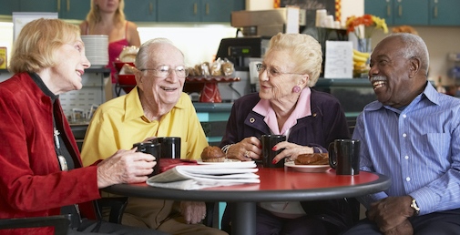 Older people drinkin coffee and laughning