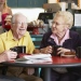 Older people laughning and drinking coffee